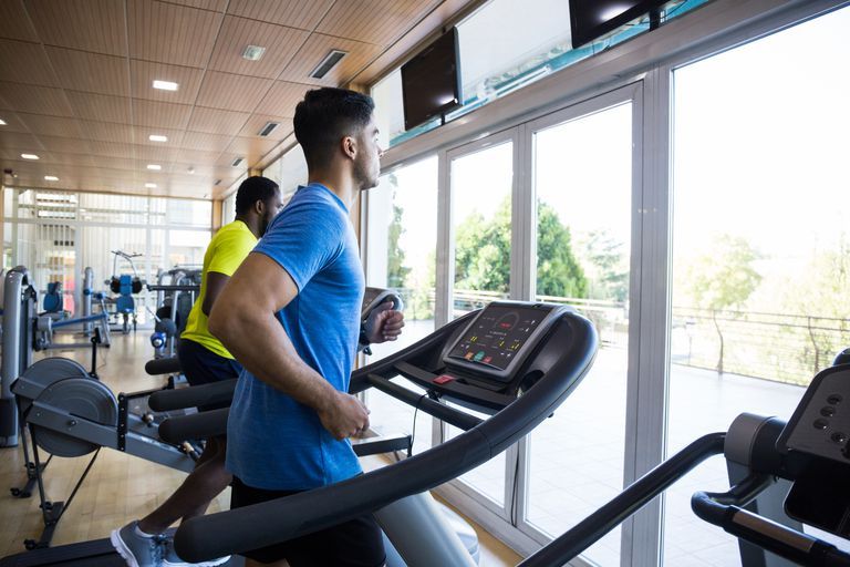 Men Running On Treadmill At Gym