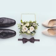 bride and groom accessories wedding shoes, bow tie and bouquet on white background, panorama  in a story about how men have to get involved in wedding planning