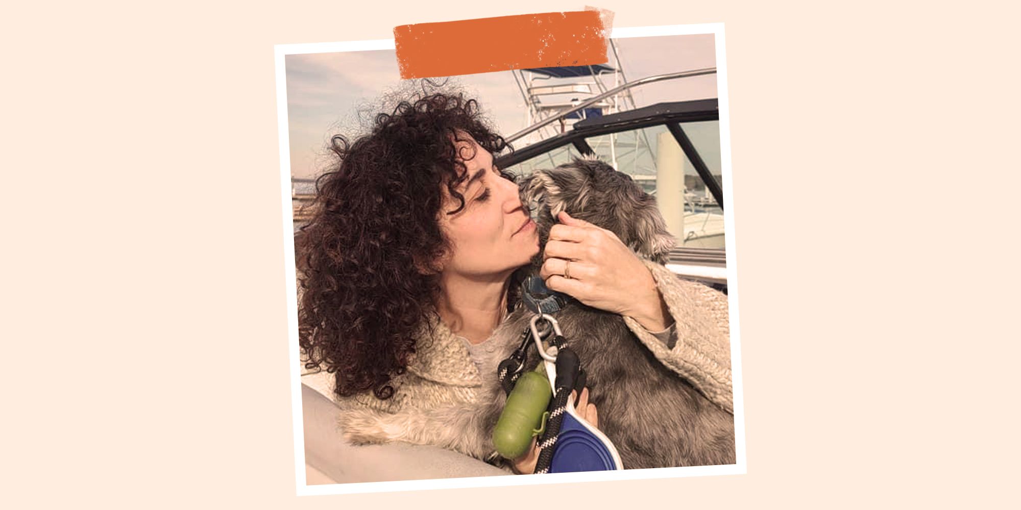 stephanie dolgoff snuggling her dog on a boat