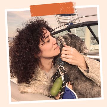 stephanie dolgoff snuggling her dog on a boat