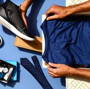 men holding sneakers, grooming products and shirt