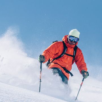 man in orange jackets skiing