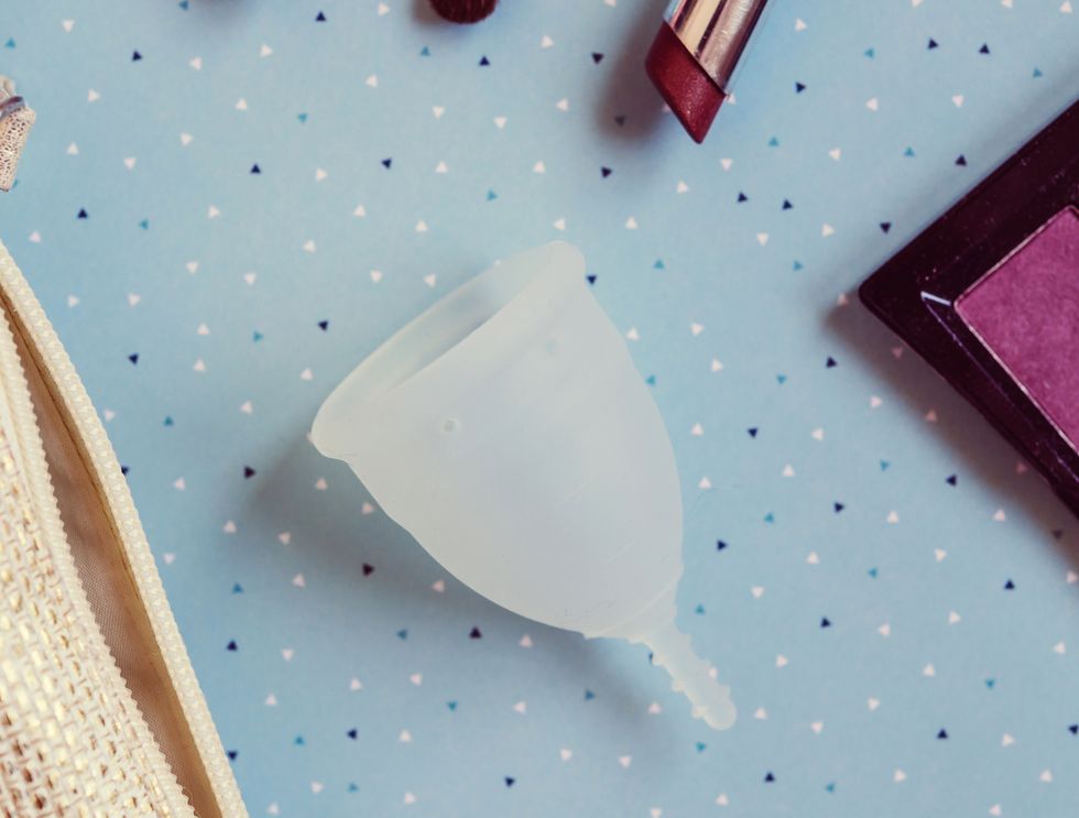 Menstrual cup on blue background
