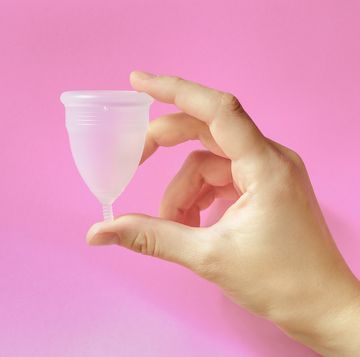 menstrual cup on pink background, feminine hygiene
