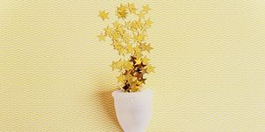 menstrual cup with sparkling stars on yellow background