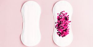 Menstrual pad with pink glitter on pastel background