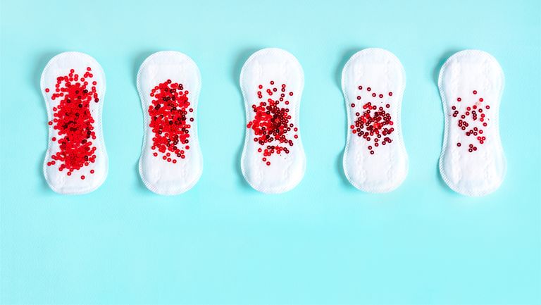 menstrual pads with red glitter on colored background