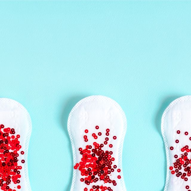 menstrual pads with red glitter on colored background