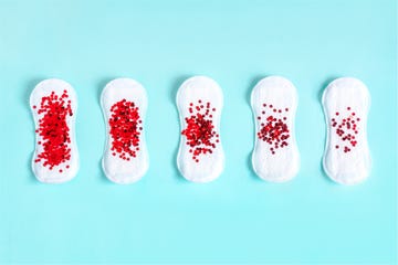 menstrual pads with red glitter on colored background