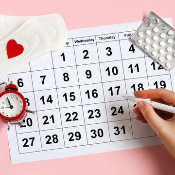 menstruation calendar with pads, alarm clock, hormonal contraceptive pills female's menstrual cycle concept menstrual retardation concept