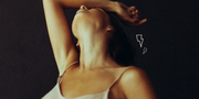 a woman looking stressed out with her hand on her forehead and her head tilted back