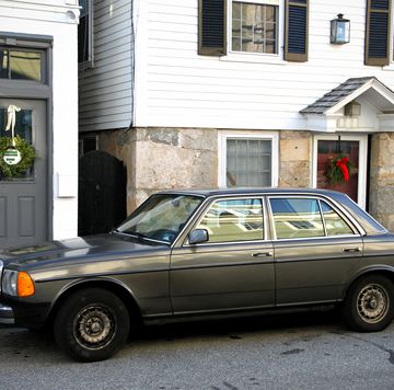 a mercedes diesel parked in front of a house