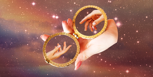 a hand holds a mirror that shows two more hands reaching out to each other