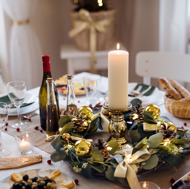 a decorated table set for dinner meal at christmas time
