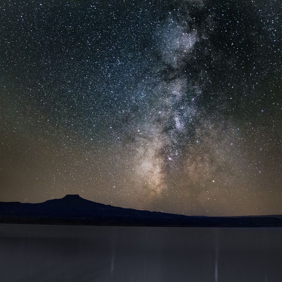 mesmerizing view of the lake and the mountains under the starry sky in ghost ranch, new mexico