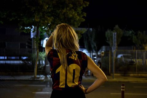 a fan wearing a jersey of barcelona's argentinian forward lionel messi gestures as supporters gather in front of the camp nou stadium in barcelona on august 5, 2021   lionel messi will end his 20 year career with barcelona after the argentine superstar failed to reach agreement on a new deal with the club, the spanish giants announced on august 5, 2021 photo by pau barrena  afp photo by pau barrenaafp via getty images