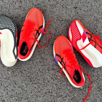 two pairs of red and black cushioning shoes designed for racing two pairs of red and black cushioning shoes designed for racing
