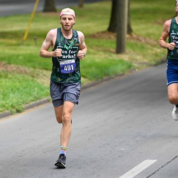 runners participating in a race wearing matching tank tops and numbered bibs runners participating in a race wearing matching tank tops and numbered bibs