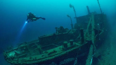30 Stunning Shipwrecks That Will Blow Your Mind scuba diving, underwater, underwater diving, water, shipwreck, recreation, diving, diving equipment, vehicle, ship,