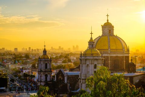 Scenic view of Guadalupe Cathedral and Mexico City skyline at sunset, Mexico