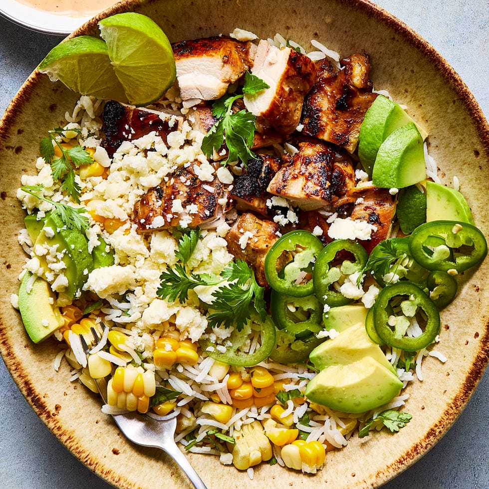 rice bowl filled with chicken, corn, avocado, and jalapeno slices