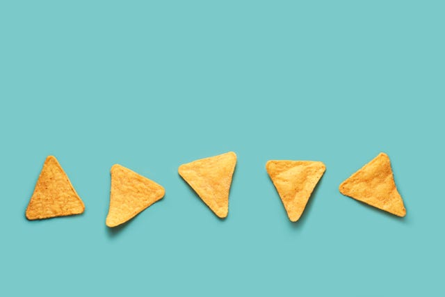 mexican nacho corn chips lying on a blue turquoise background mexican cuisine