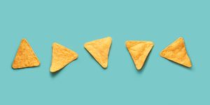 mexican nacho corn chips lying on a blue turquoise background mexican cuisine