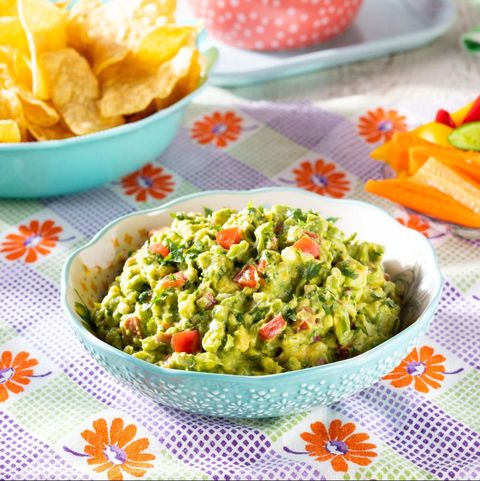 mexican recipes guacamole in light blue bowl with floral linen