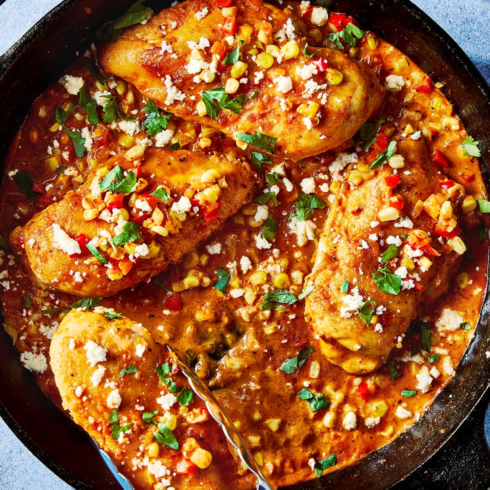 chicken and corn in a skillet with a creamy sauce