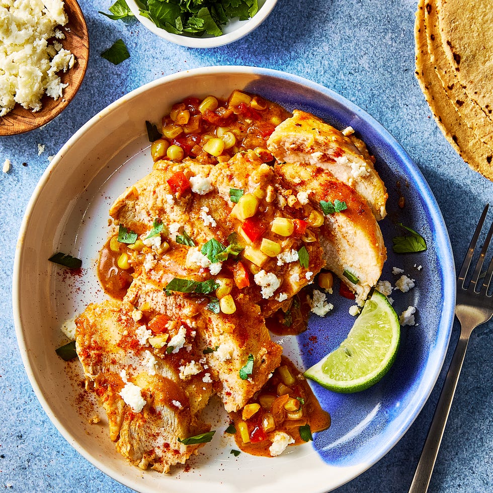 chicken and corn in a skillet with a creamy sauce