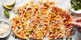 flatbread topped with corn, cheese, and cilantro