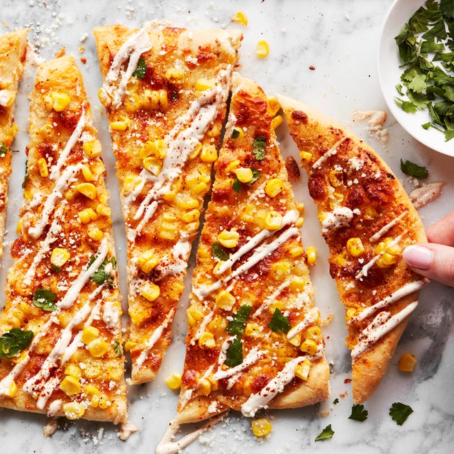 flatbread topped with corn, cheese, and cilantro