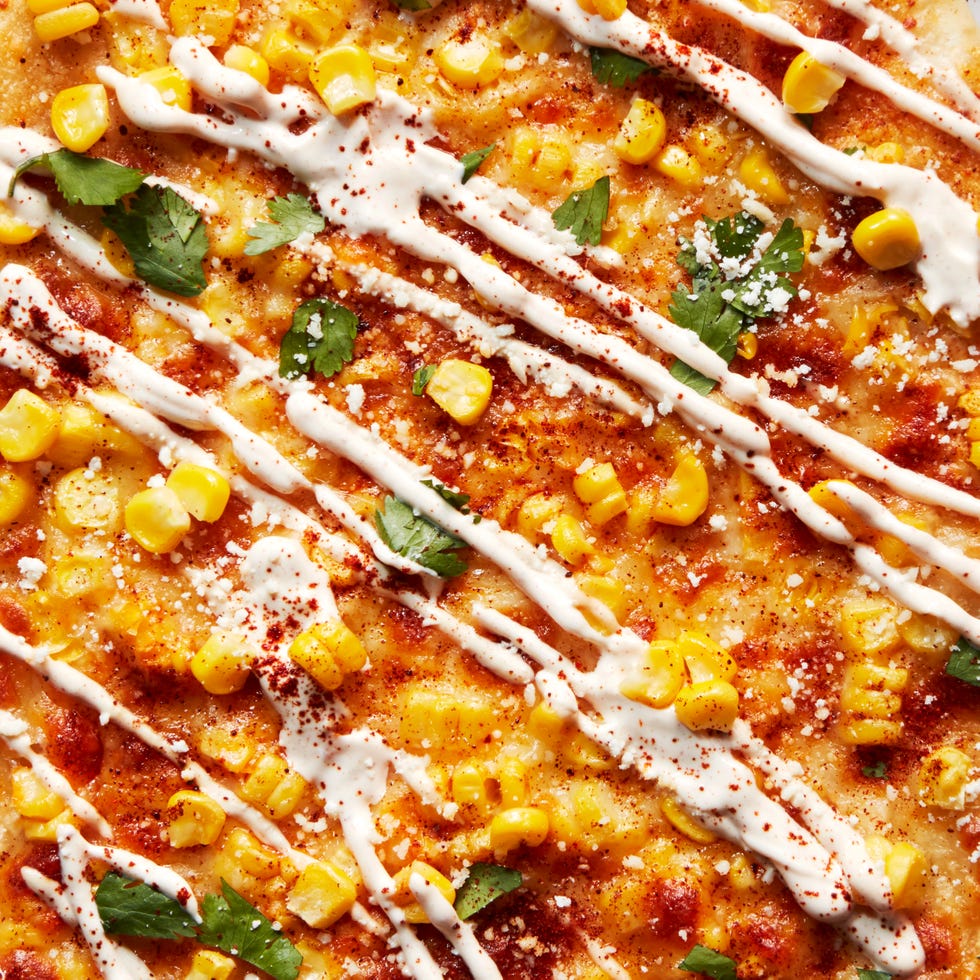 flatbread topped with corn, cheese, and cilantro