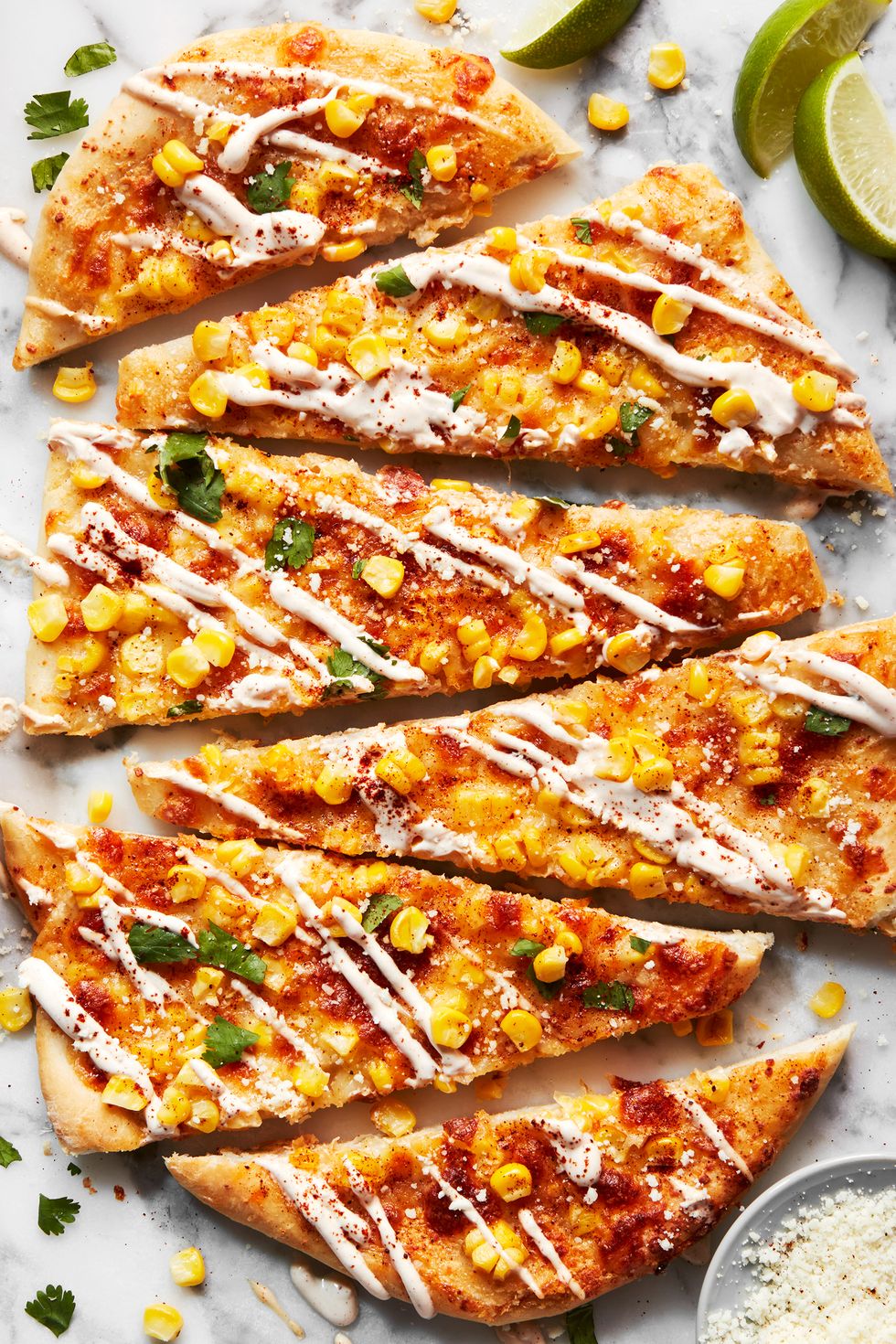 flatbread topped with corn, cheese, and cilantro