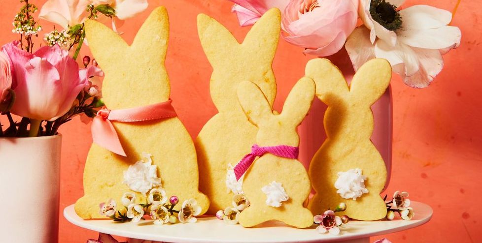 meyer lemon bunny cookies with flowers on a white cake stand