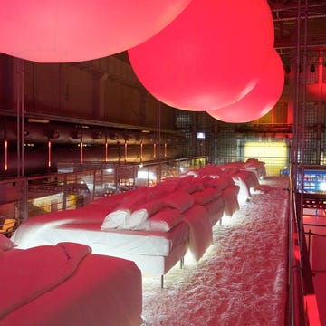 a room with red and white beds