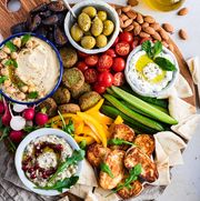 mezze platter with dips, cucumbers, tomatoes, falafel