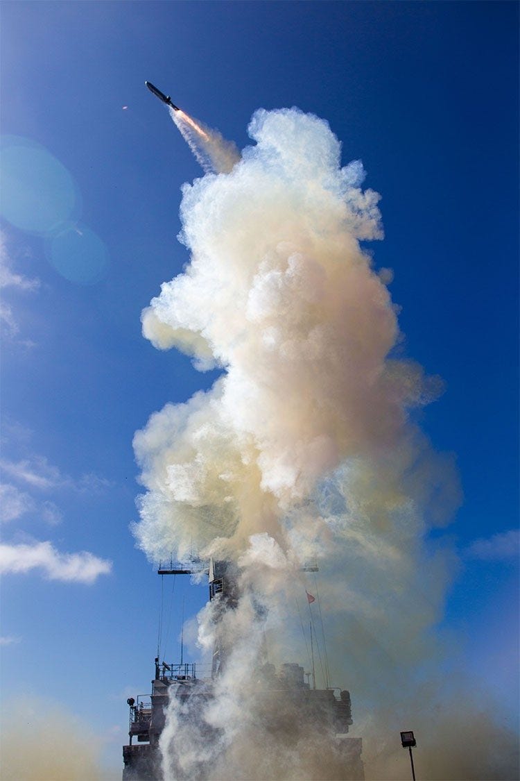 Irasm rocket launch with cloud of smoke and steam against blue sky