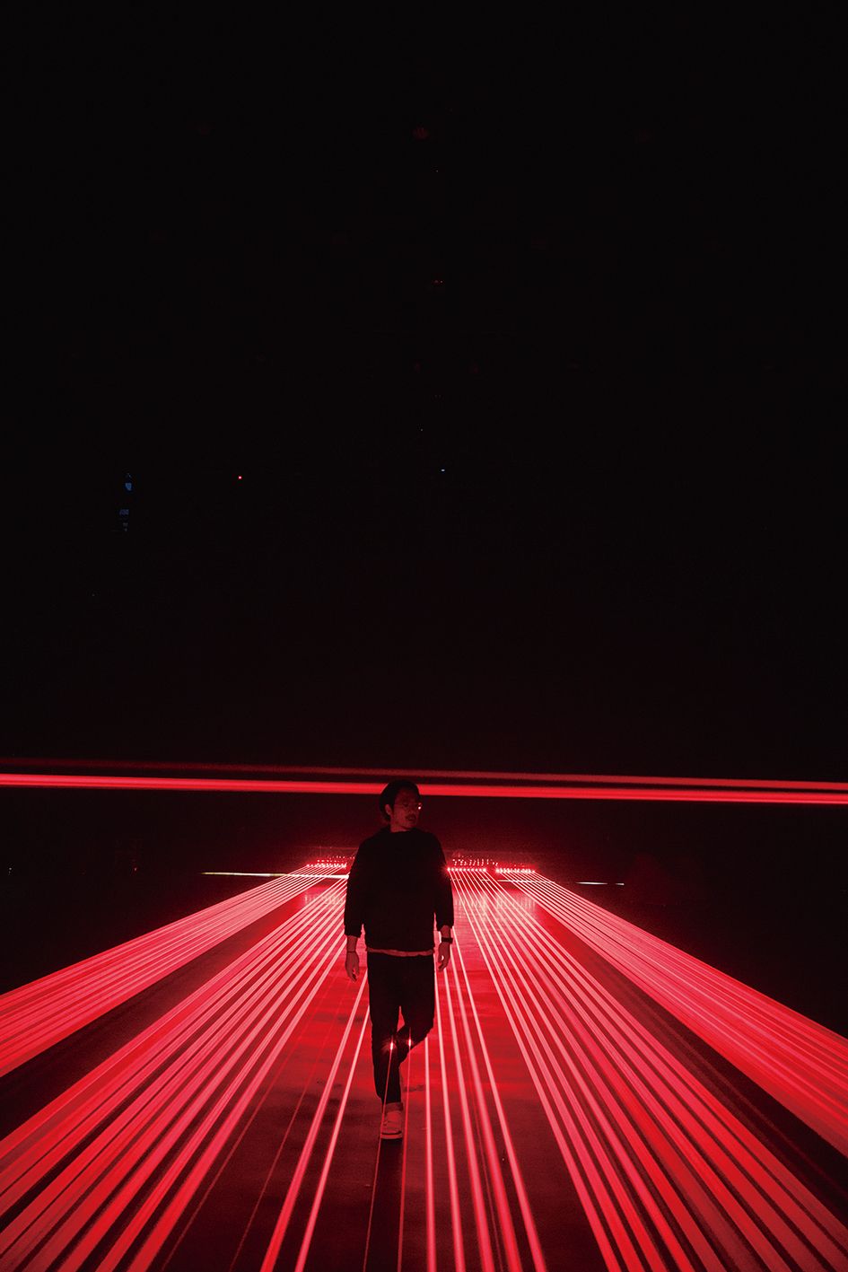 a person walking on a red lit stage