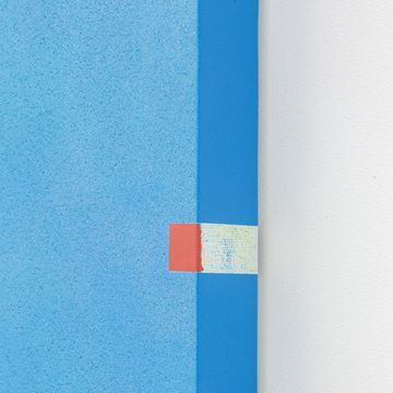 a blue wall with a red and yellow square on it