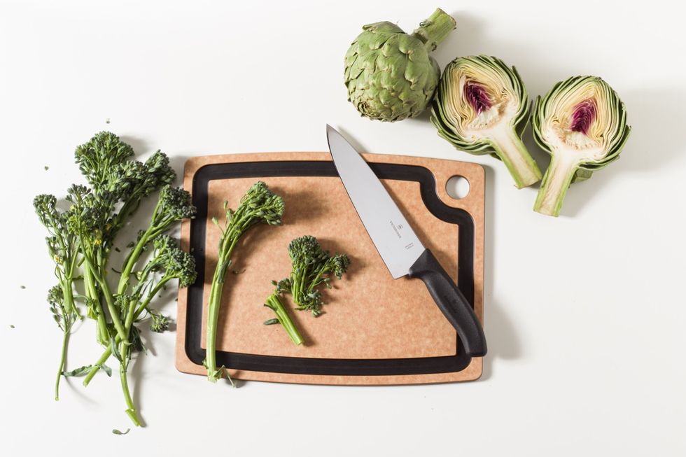 cutting board with knife and veggies