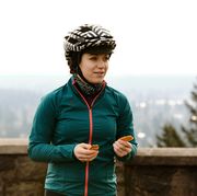 female cyclist eating an energy bar during a ride