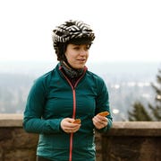 cyclist nutrition female cyclist eating an energy bar during a ride
