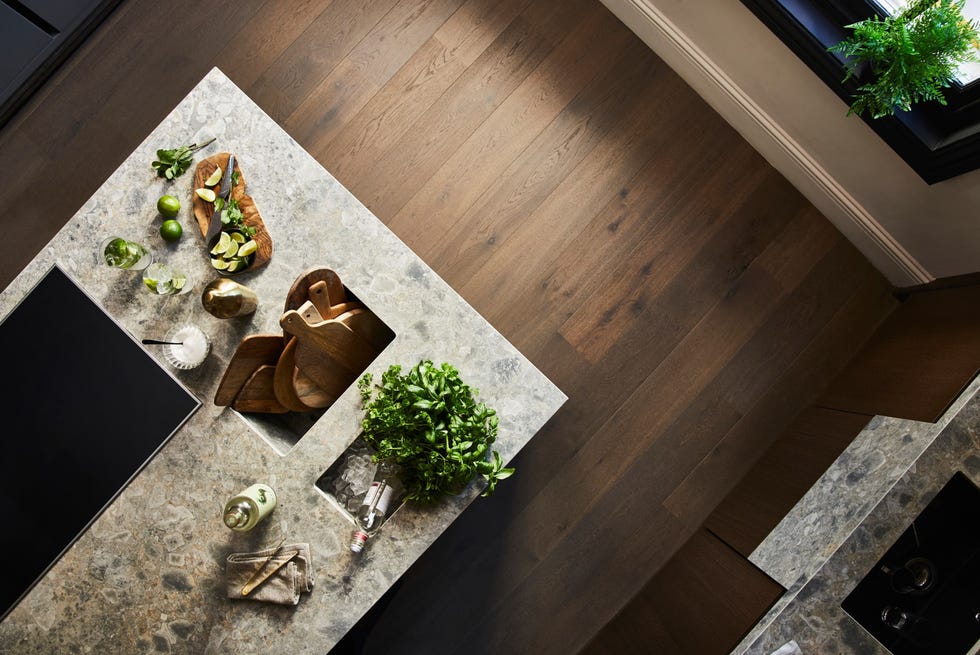 Kitchen island with food and dark wooden floors