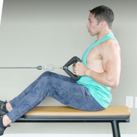 a person sitting on a bench with a person holding a barbell