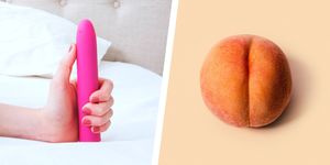 a hand holding a vibrator and a peach