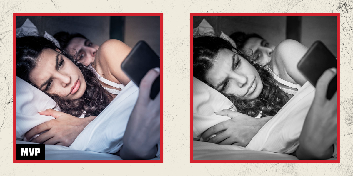 woman on phone while boyfriend peers over her shoulder in bed