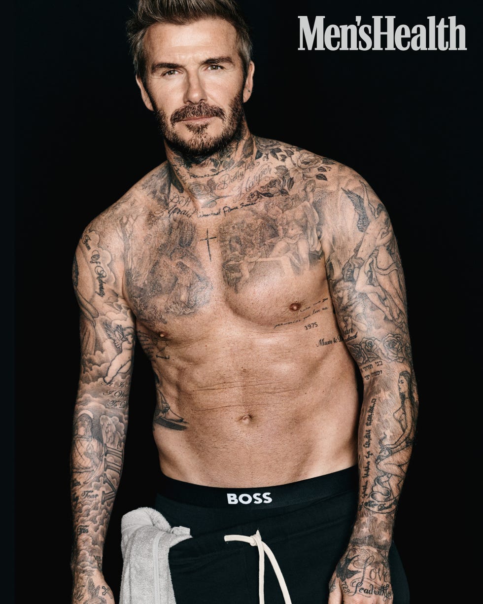 a muscular male figure showcasing intricate tattoos on the torso and arms