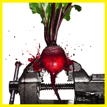 a beet in a vise getting squashed and exploding beet juice