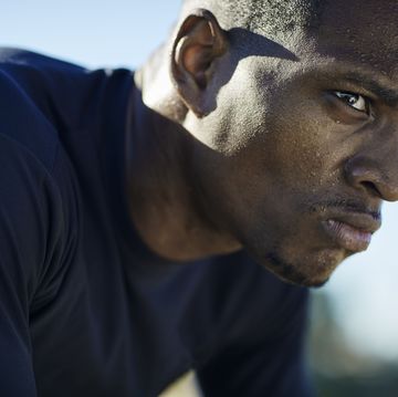 black man wearing black tshirt with visible sweat on face